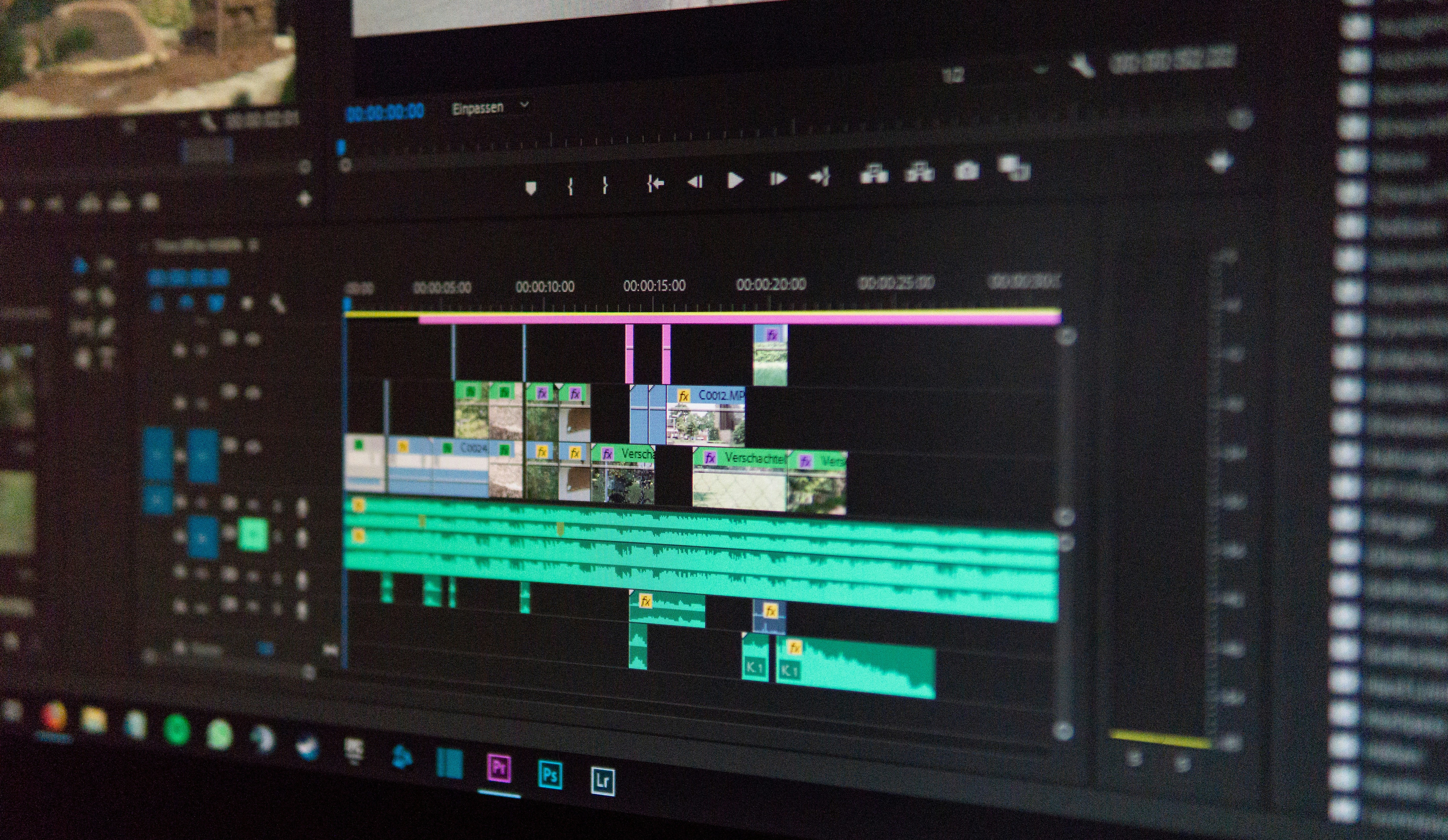 A computer screen displaying a video editing timeline with various clips and audio tracks.